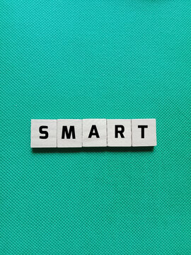 Alphabet letters of the word SMART concept on a green background. Concept photo about a device or system that can think, learn, or act automatically using digital technology.