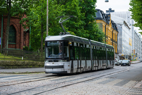 Helsinki, Finland - August 05 2025: Modern tram traveling along city street in Helsinki.