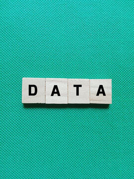 Alphabet letters of the word DATA concept on green background. Photo about data storage and information technology.