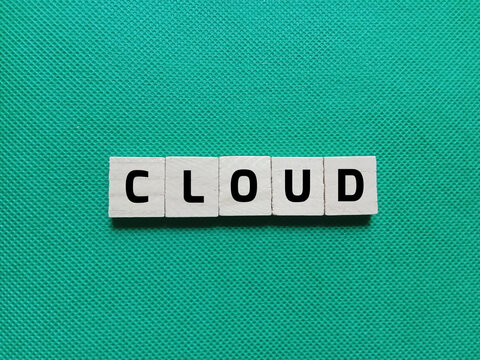 Alphabet letters of the word CLOUD on a green background. Concept photo about the storage and use of data or systems via the internet.