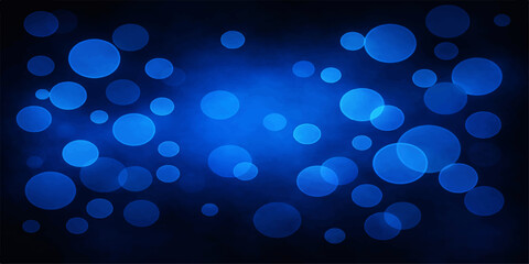 A glowing blue abstract bokeh background features bright defocused glitter and shiny illuminated circles that create a magic holiday glow for a night party decoration © MdShakibAhamed