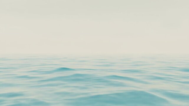 Calming ocean waves gently rolling on a serene light blue body of water