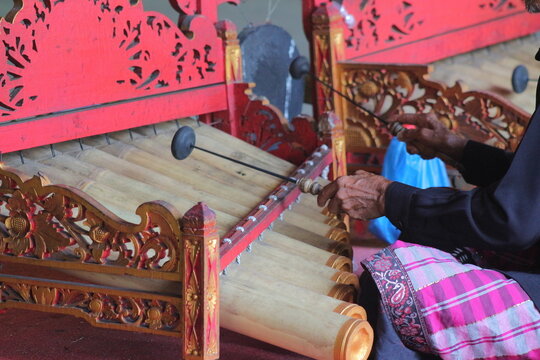 A Balinese gamelan. A hand beat the gamelan made from bamboo. A Balinese instrument. A traditional Indonesian intrument. 