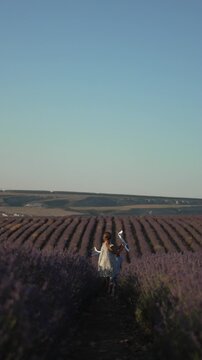 Girl running lavender field toy airplanes childhood dream freedom imagination Vertical video