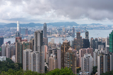 Fototapeta premium View of Hong Kong and Kowloon from Victoria peak. Panorama of Hong Kong, skyscrapers and nature. 21 May 2025, Hong Kong, China
