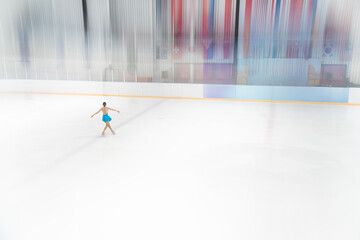 Graceful Ice Skater Performing Pirouette on Empty Rink © phaitoon
