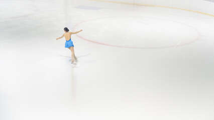 Elegant Ice Skater Gliding Gracefully on Smooth Ice Rink Surface © phaitoon