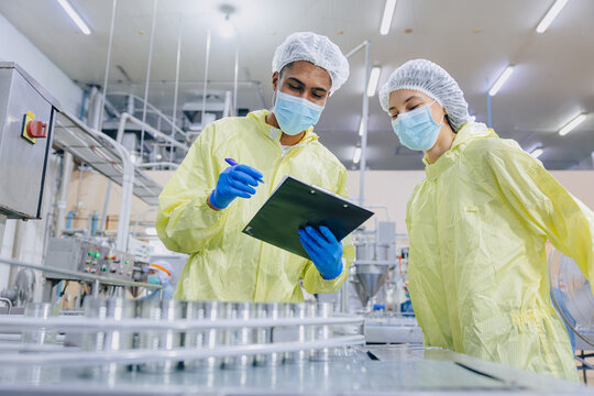 Food hygiene inspector team work examination food production process in line at cannery food factory