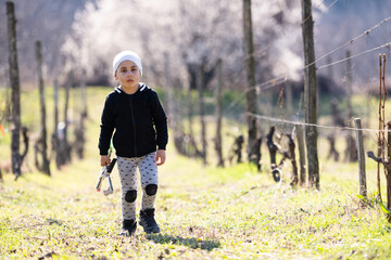 Young child walking in vineyard holding toy gun © Zoran Jesic