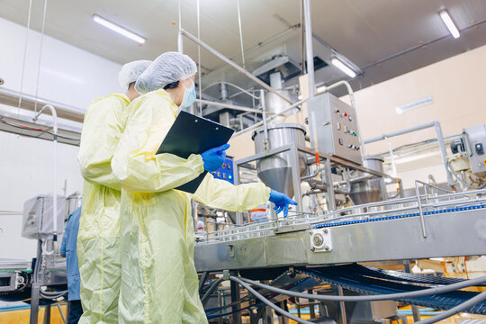 Food hygiene inspector team work examination food production process in line at cannery food factory