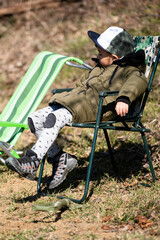 Fototapeta premium Toddler sleeping in outdoor camping chair