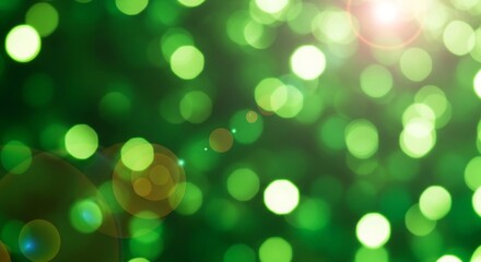 Obraz premium Abstract green bokeh lights with a bright sun flare creating a magical and festive atmosphere.