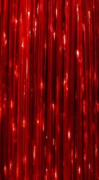 Vibrant red curtain with shimmering lights in a festive atmosphere, captured from a straight-on viewpoint