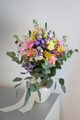 Fototapeta premium Vibrant Mixed Flower Bouquet in a White Vase