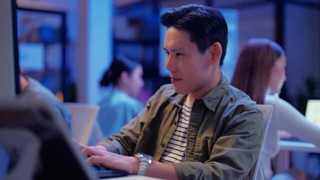 Asian programmer works late night office coding deep learning AI models, training neural networks with intense concentration and focus, dedicating overtime hours alone to machine learning development	