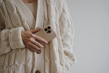 Neutral Aesthetic Fashion Detail With Cable Knit Cardigan, Phone In Hand, Soft Light