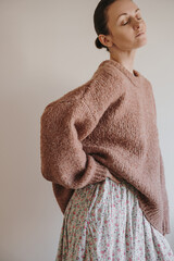 Scandinavian Style Outfit With Woman In Warm Knitwear Posing In Soft Natural Light