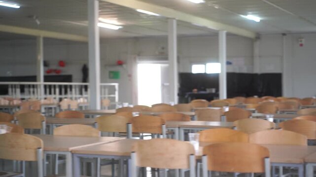 Modern interior of cafeteria or canteen with chairs and tables, eating room in selective focus. canteen at the factory