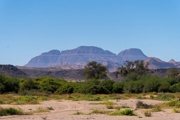 The Kunene Region in northwestern Namibia is a remote and sparsely populated area known for its dramatic desert landscapes, rugged mountains.