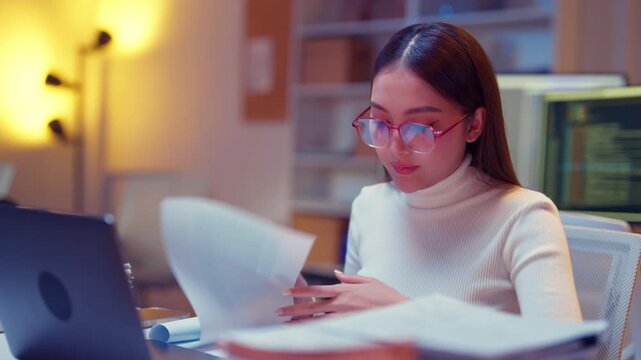 Asian female smart programmer works late night office coding deep learning AI models, training neural networks with intense concentration and focus, dedicating overtime hours alone to machine learning