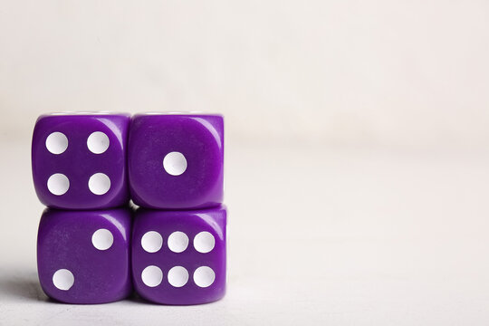 Purple dices on light background