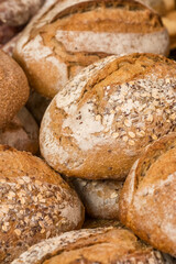 Assorted crusty artisanal bread loaves with seeds