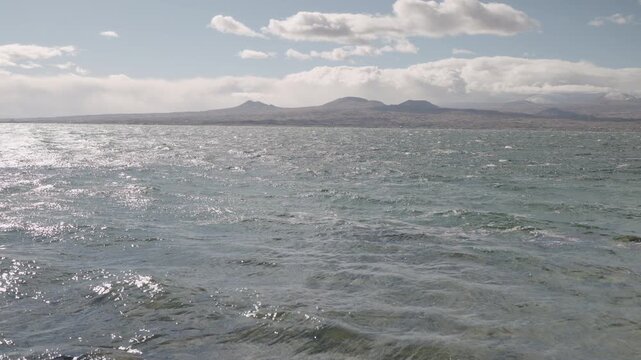 Slow motion handheld footage of lake Sevan in Armenia windy autumn season