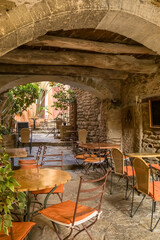 Rustic Restaurant Terrace Under Ancient Stone Arch in Bormes les Mimosas