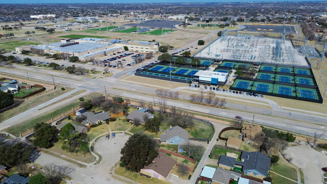 School buildings, courts, fields, educational utility facilities near Premier Dr and Spring Creek Pkwy lie west of Clearview Park by neighborhood streets, mixed use development in Plano, Texas