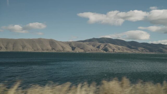 Slow motion handheld footage of lake Sevan in Armenia windy autumn season