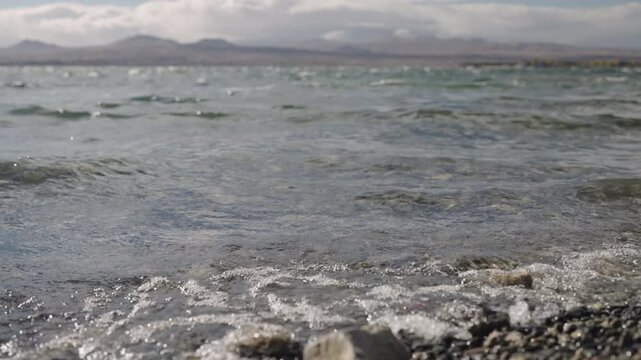 Slow motion handheld footage of lake Sevan in Armenia windy autumn season
