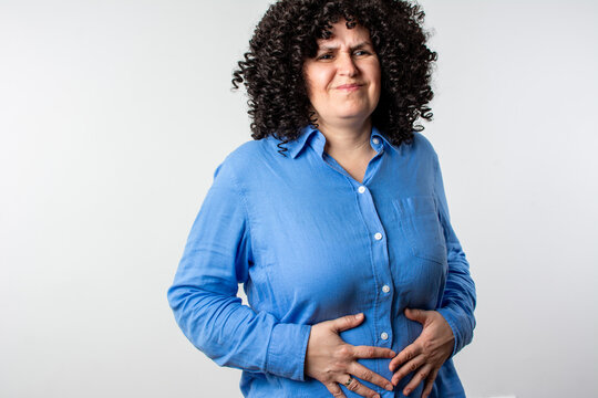 Stomach ache, cramps and hands of woman with abdomen pain due to constipation, menstruation or ibs issue. 