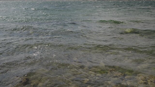 Slow motion handheld footage of lake Sevan in Armenia windy autumn season
