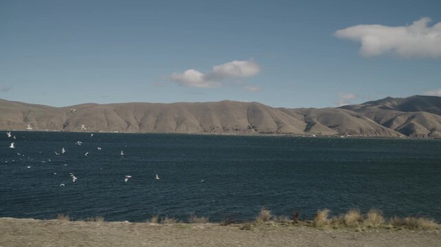 Slow motion handheld footage of lake Sevan in Armenia windy autumn season
