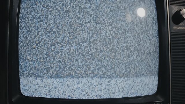 Close-up of a retro television with a screen of flickering static