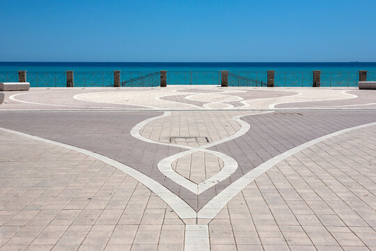 Geometric pavement patterns on the deserted esplanade: Via Marina, Roccella Ionica, Calabria, southern Italy