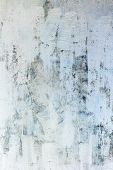 Fototapeta premium Abstract textured gray and white wall with brush strokes and weathered surface