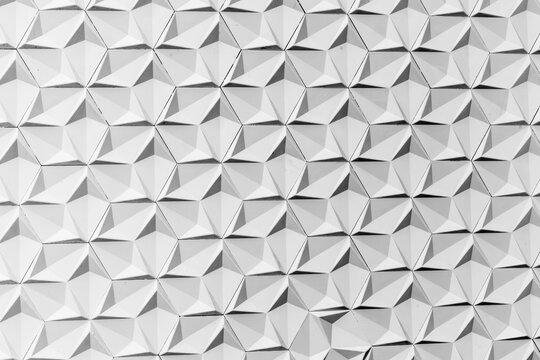 Geometric pattern of white 3d triangular tiles with shadow effect