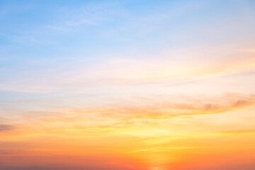 Beautiful sunrise sky with vibrant gradient orange and gold colors and soft blue, Clear atmosphere with wispy clouds. Peaceful, perfect for background and copy space, High resolution images