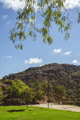 Obraz premium Group of people riding horses on a sunny day at a ranch