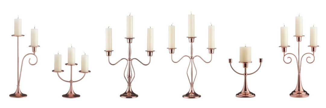 Various copper candelabras with white candles isolated on a transparent background
