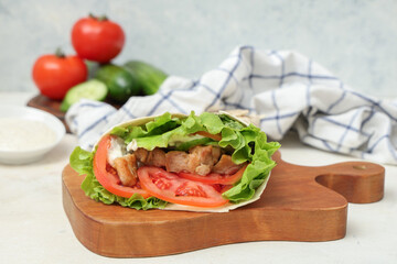 Board with tasty doner kebab on light  table