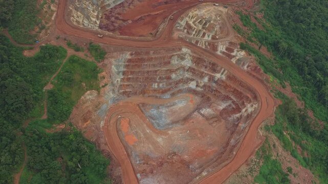 Open pit bauxite mine aerial view with trucks transporting ore