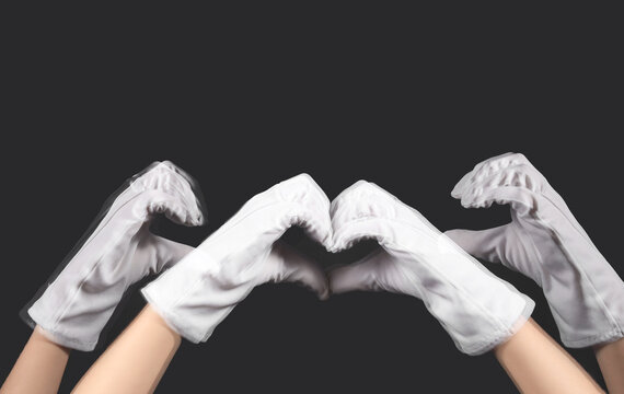 Stroboscopic photo of moving woman in gloves making heart gesture on dark background