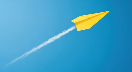 Yellow paper airplane with white trail soars across a bright blue sky