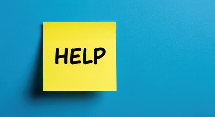 Yellow sticky note with "HELP" written in black marker on a blue background