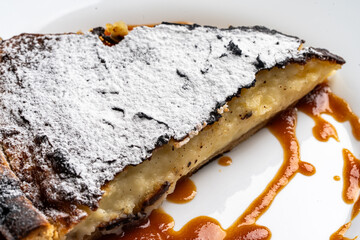 Fototapeta premium Dessert, a traditional French flan with salted caramel on a white plate. Close-up