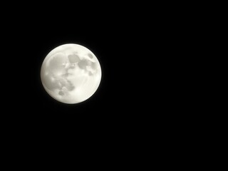 Obraz premium Enormous pearl-like moon hangs in velvety black sky, casting ethereal glow, cosmos, night