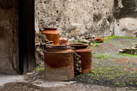 Ancient Roman large terracotta storage jars and ruins in Pompeii Italy