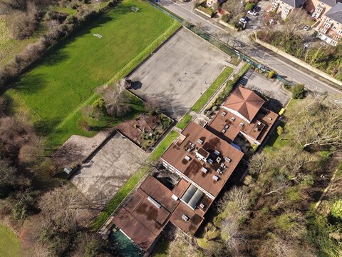 High‑angle view of Birkenhead streets and housing estate in warm sunlight.